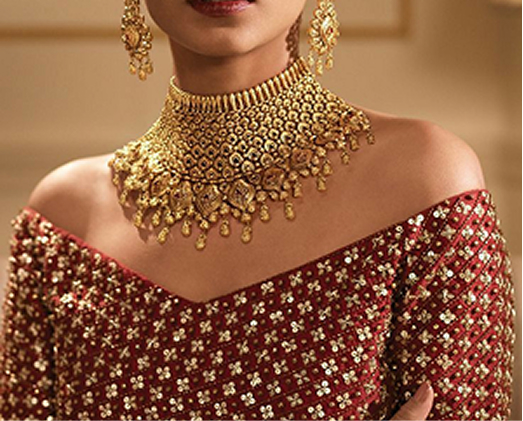 Close-up of traditional gold necklace on red outfit